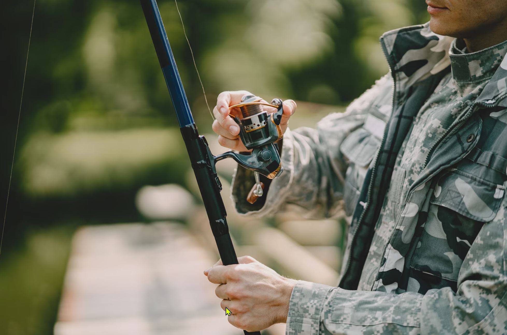 Free photo man fishing and holds the angling rod